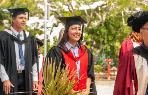 Graduation - student walking and smiling