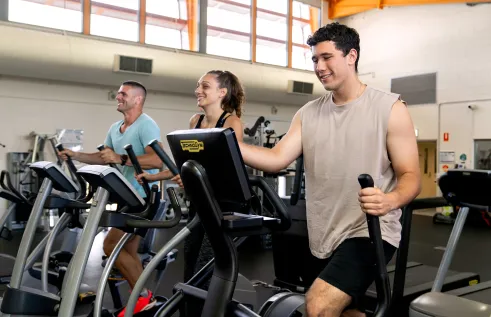 People working out on exercise machines.