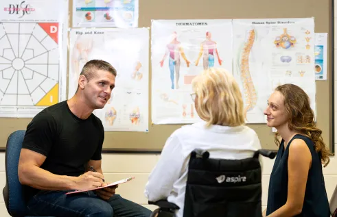 Health student sitting down with clients
