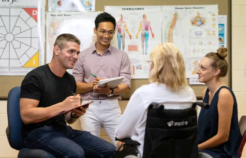 Students with clients at the Health Hub