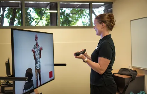 Participant and instructor working out in an online session