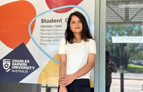 mpp female student stands in front of doors