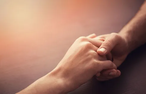 An image of a hand holding another hand