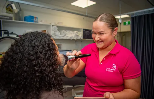 young student applies make up