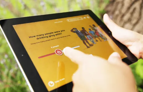 Hands hold an ipad showing the Grog Survey App