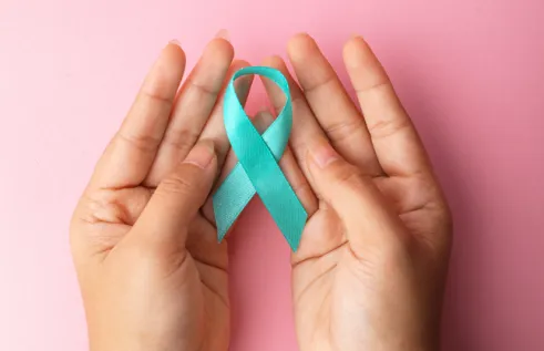 Image of hands holding a teal ribbon