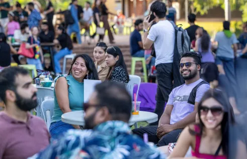People sitting at tables and chairs enjoying the Boab Breeze Social Sunset event