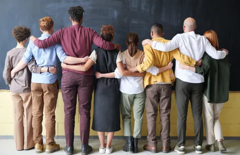 People in a line with their backs to the viewer