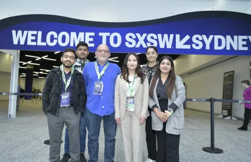 Students stand in front of innovation expo