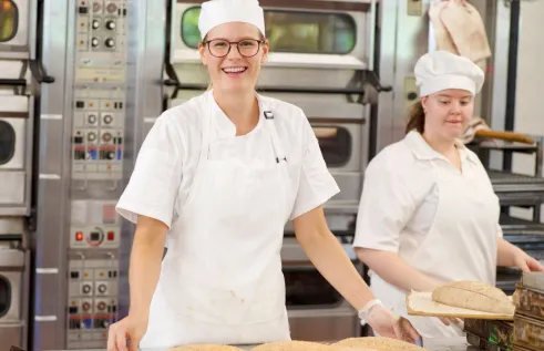 Two students working in a bakery