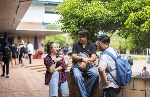 Group of three students interacting on the Casuarina campus