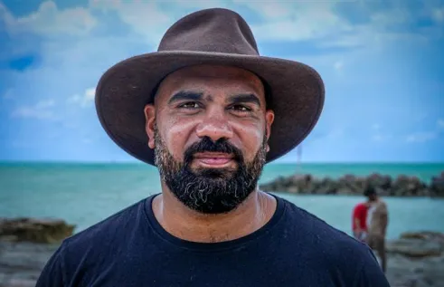 Yolngu man stands in front of jetty