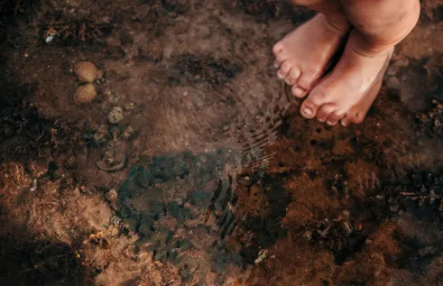 Child's Feet on Watery Shore by Bobbi Lockyer