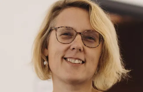 photo of woman with glasses smiling