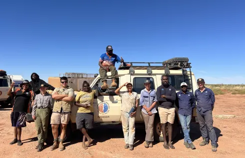 Group of people standing in front of a Landcruiser