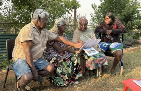 Ian Gumbula sitting with Indigenous Researchers