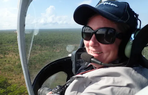 Dr Natalie Rossiter-Rachor conducts helicopter testing of a mobile application in Litchfield National Park. The app enables aerial mapping of gamba grass and other weeds at a landscape scale. Photo: NESP Resilient Landscapes Hub.