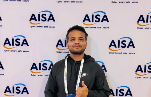 student gives thumbs up in front of AISA sign