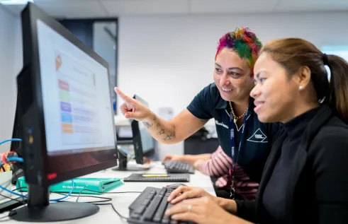 Two people looking at a computer screen