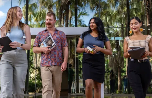 3 women and 1 men walking 