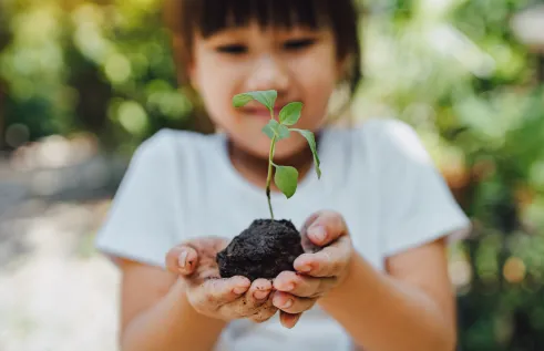 girl holding plant 