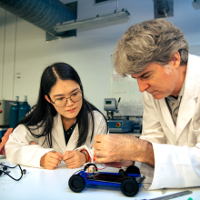 Charles Darwin University (CDU) Science lecturer Stephen Reynolds and graduate Yunzhu Wang construct a solar-powered car, a task that will feature in the new science and technology elective offered to arts and humanities students.