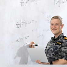 ADF student in ront of whiteboard