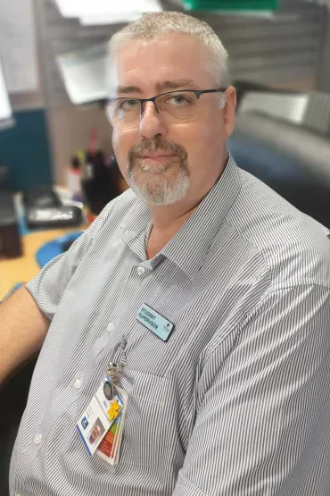 Neil sitting in his office chair