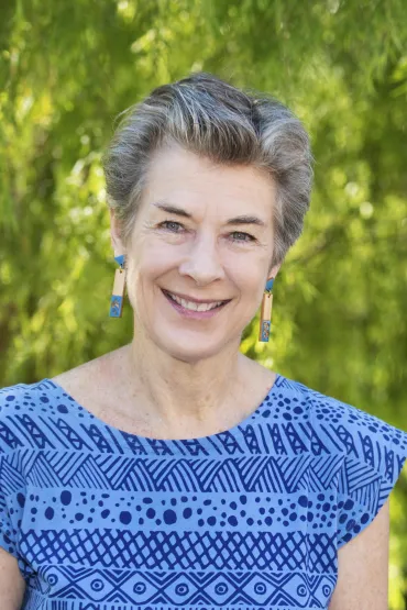 Jane Munday head and shoulders with green leafy background