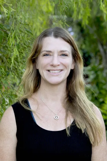 Dr Jo Randall head and shoulders with green leaves in background
