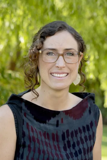 Dr Gianna Bonis-Profumo head and shoulders with green leafy background