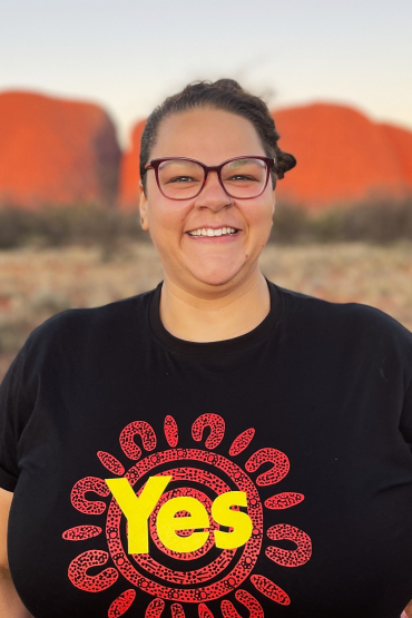 Georgie Corrie stands in front of Uluru