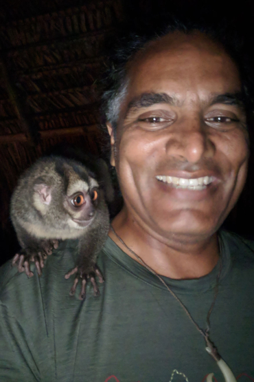 Professor Sunil Kadri, head and shoulders, with a small furry animal on his right shoulder