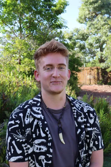 Kade Skelton head and shoulders, with trees and greenery in the background