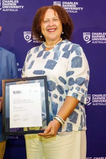 Mary holds her certificate