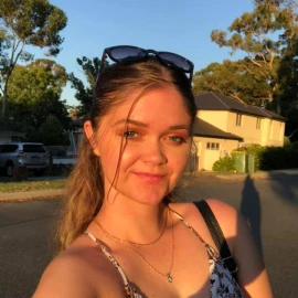 Close-up of Shailee smiling outdoors